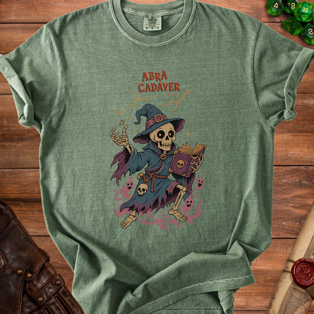 Green t-shirt with a skeleton wizard and text "Abra Cadaver" printed on it.