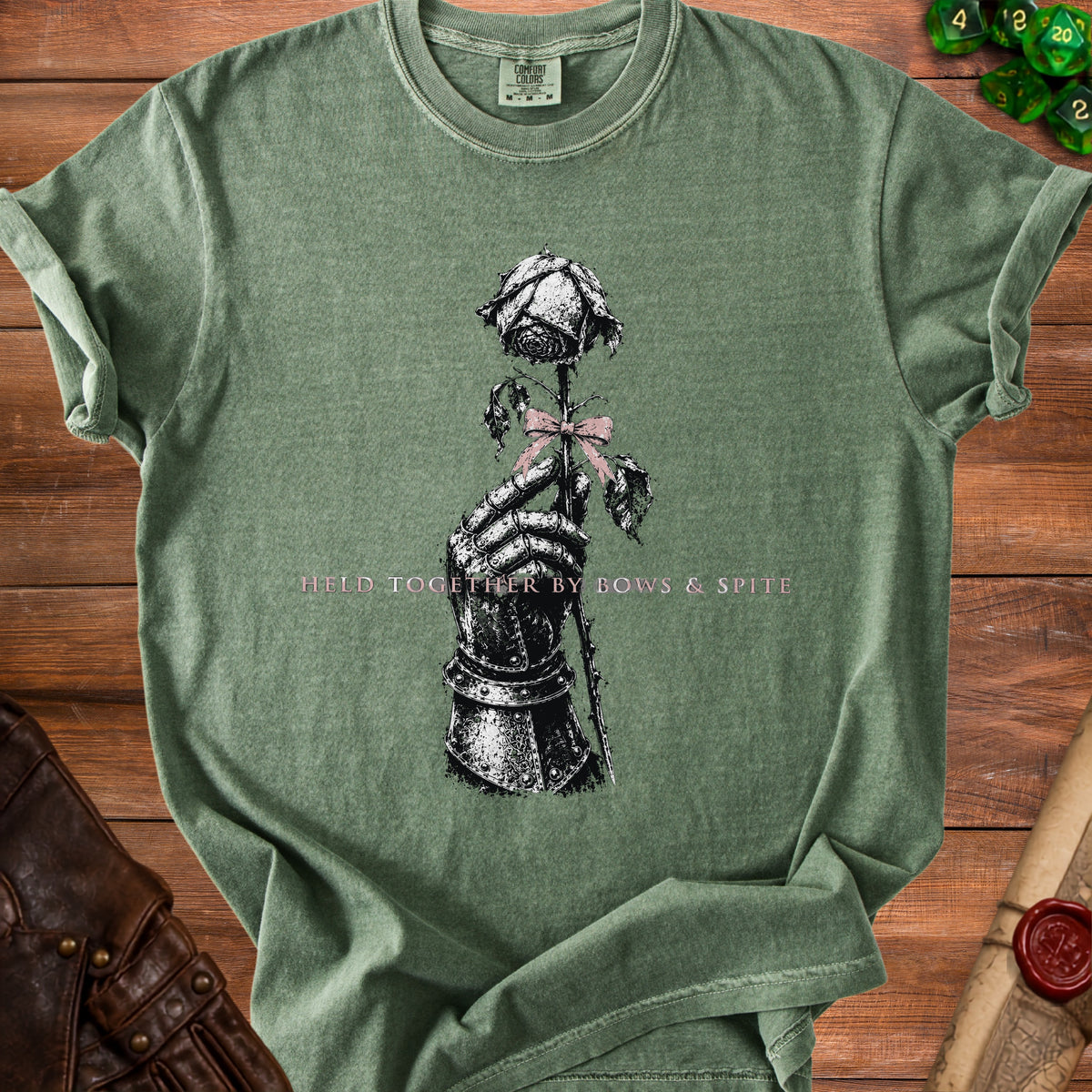 Green t-shirt with a knight's gauntlet holding a rose and text.