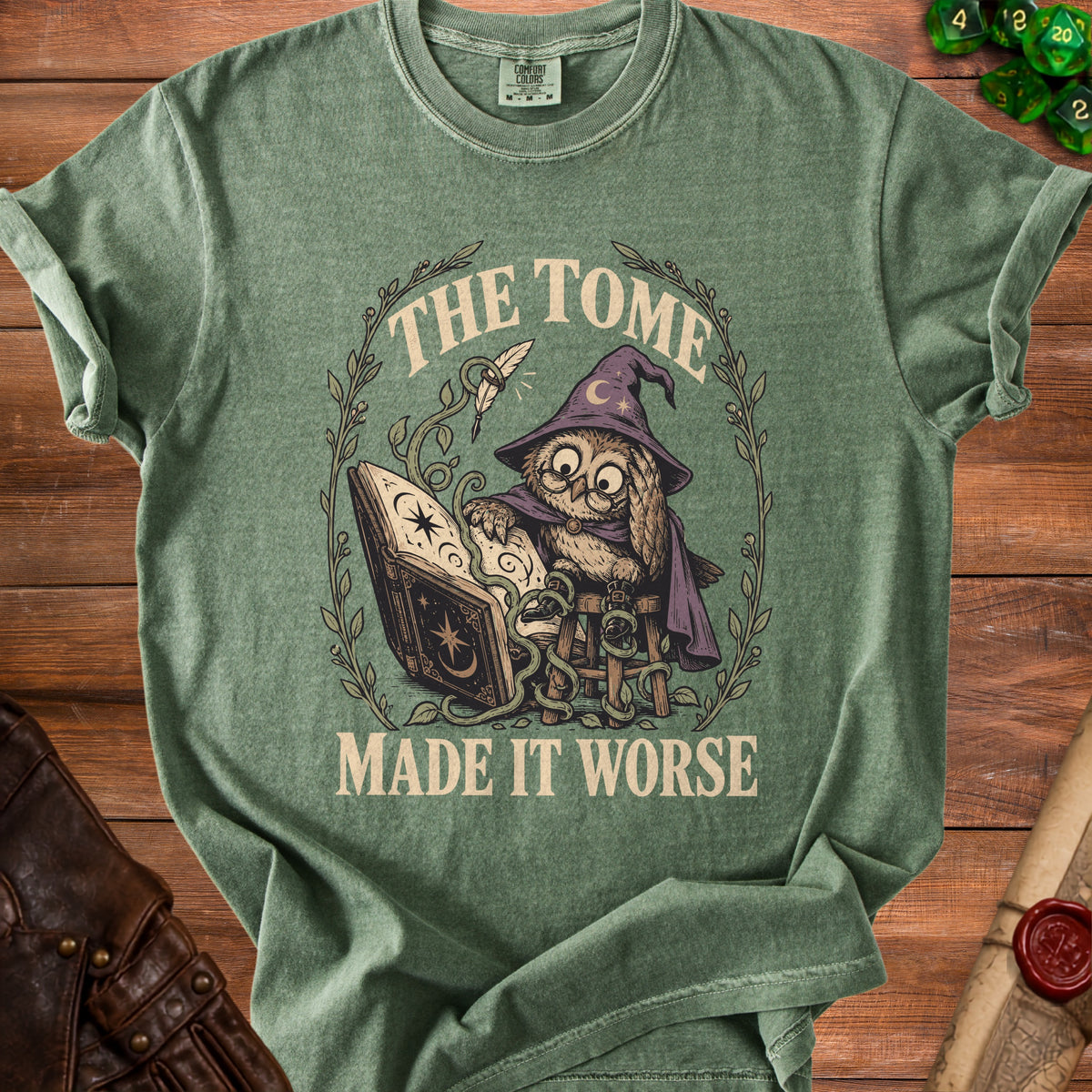 Green t-shirt with an owl wearing a witch hat reading "The Tome Made It Worse".