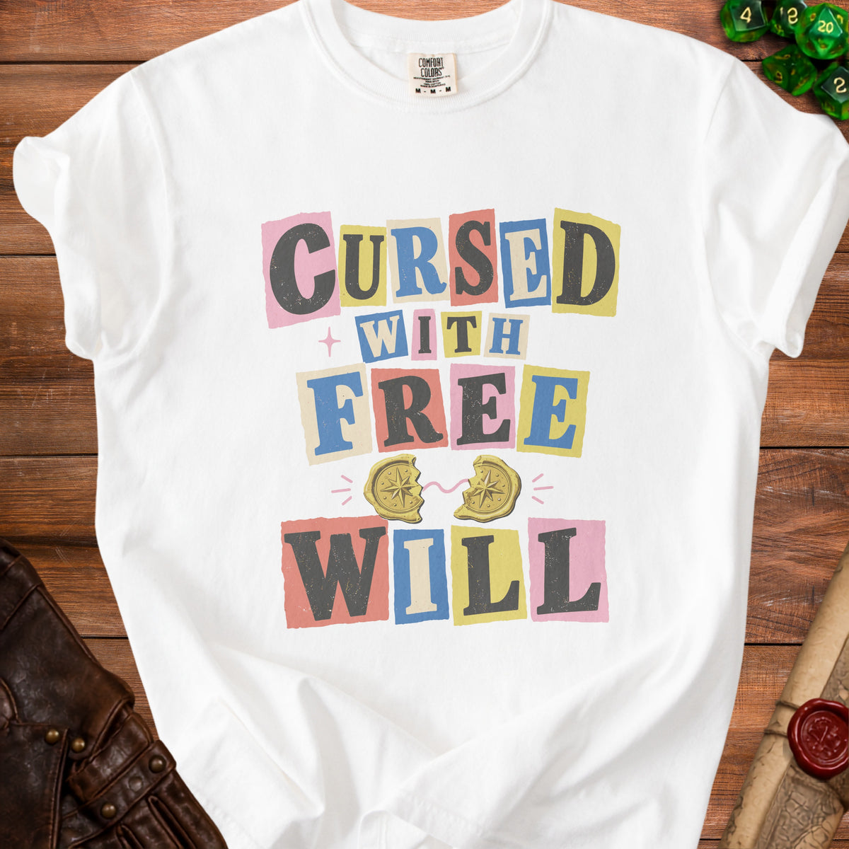 White t-shirt with "CURSED WITH FREE WILL" text and broken compass graphic.