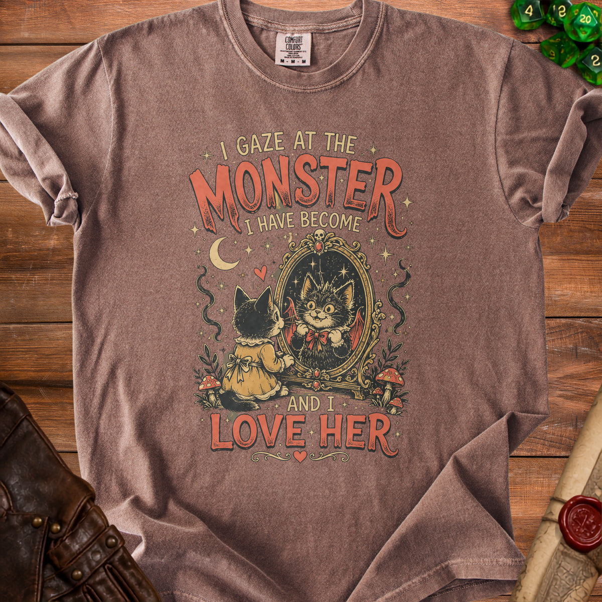 Brown t-shirt with "I gaze at the monster I have become and I love her" text and gothic cat graphic.