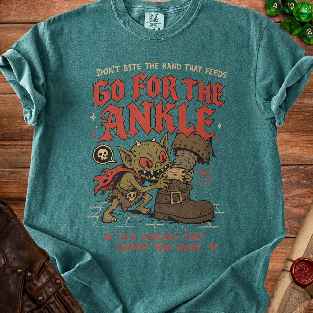 Goblin biting a boot with text "Don't bite the hand that feeds Go for the Ankle."