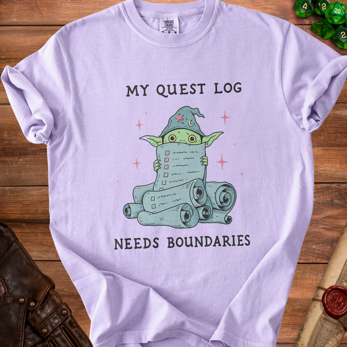 Purple t-shirt with wizard goblin holding a quest log saying "MY QUEST LOG NEEDS BOUNDARIES."