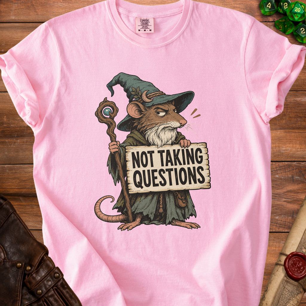 Pink t-shirt with illustration of a wizard mouse holding a staff and sign saying "Not Taking Questions".