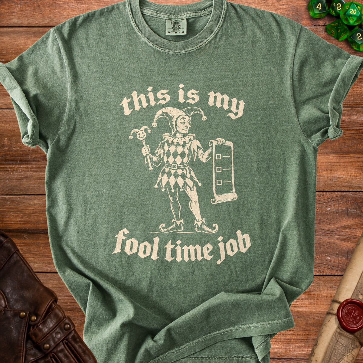 Green t-shirt with "this is my fool time job" text and a jester graphic.