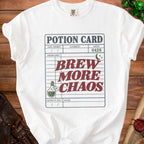 White t-shirt with a potion card graphic: "Brew More Chaos".