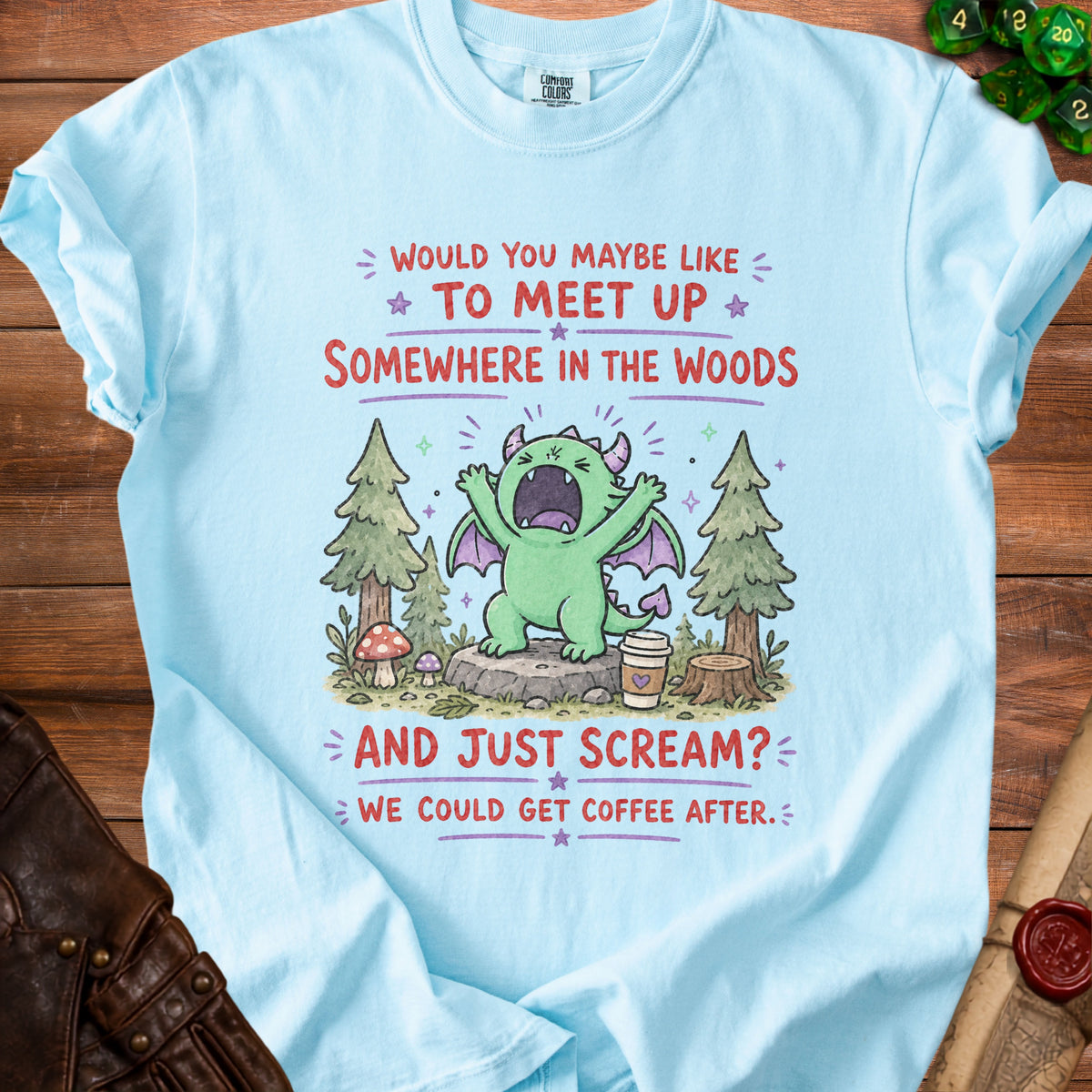 Light blue t-shirt with a cartoon dragon, woods, and text about meeting up.