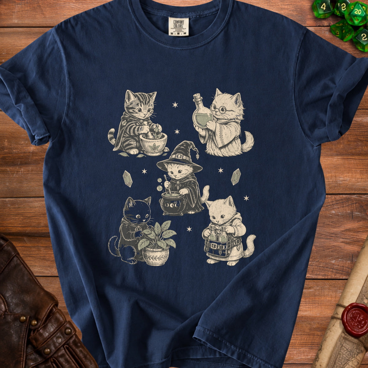 Navy t-shirt with a graphic of four cats engaging in witchy activities.