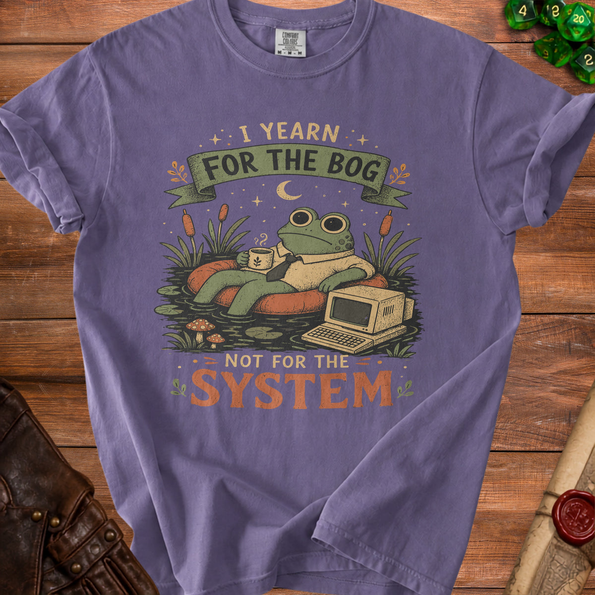 Purple t-shirt with frog, coffee, and computer graphic and text "I yearn for the bog, not for the system".