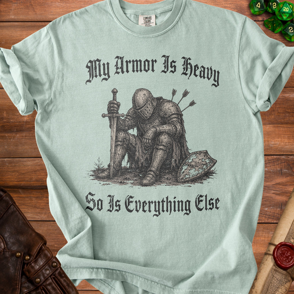 Pale green t-shirt with illustration of armored knight and text "My Armor Is Heavy So Is Everything Else".