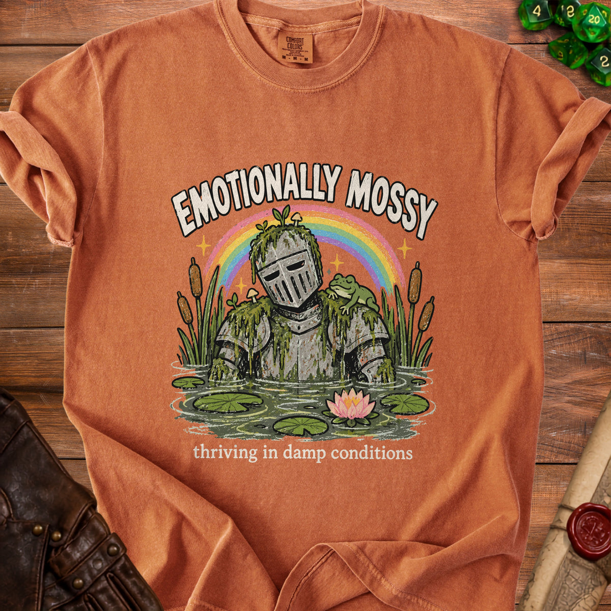 Knight in armor covered in moss, with a frog and rainbow. "Emotionally Mossy" text.