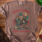 Brown t-shirt with "Minor Curses Only Make Me More Powerful" warrior graphic.