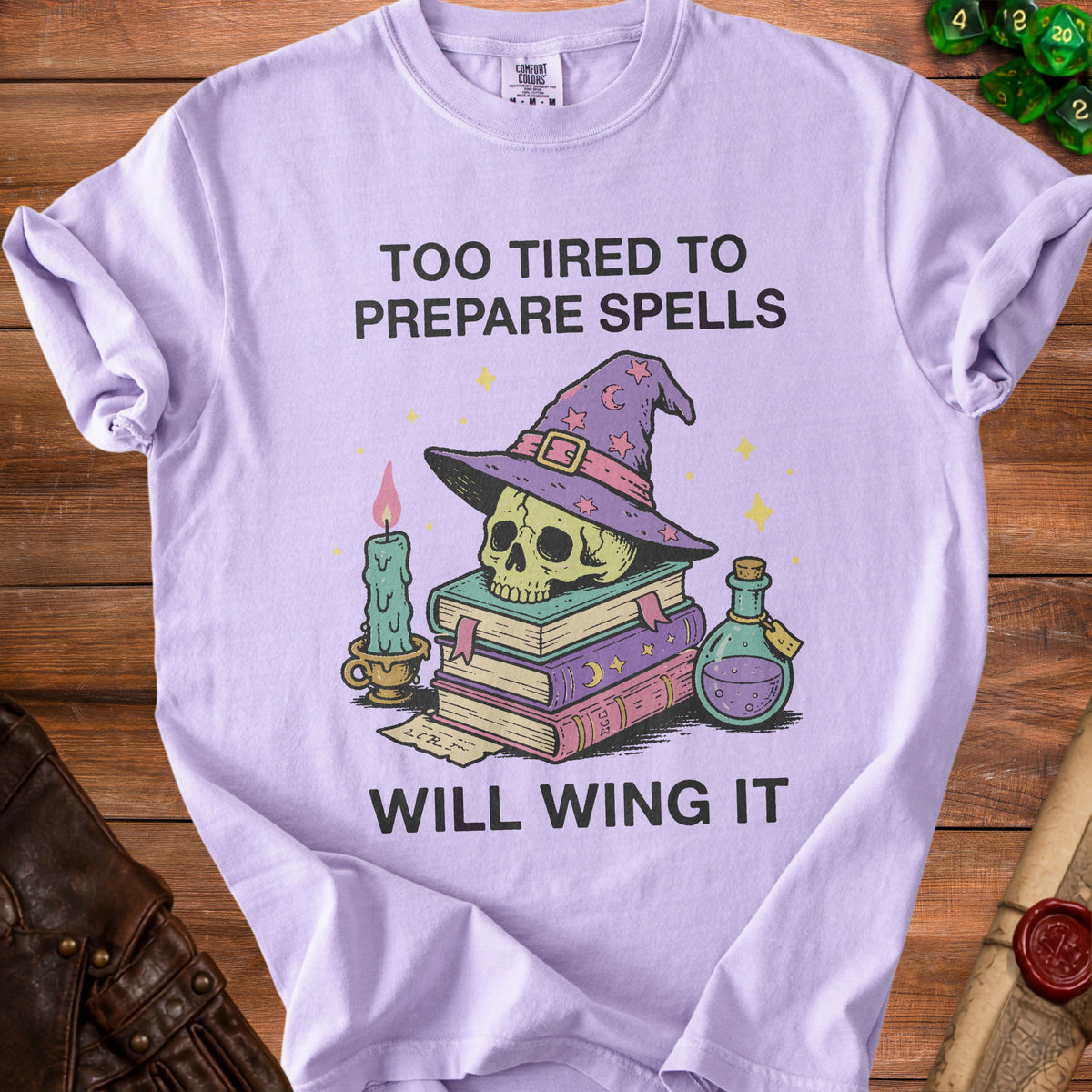 T-shirt with skull, witch hat, books, candle, and potion with text "Too tired to prepare spells will wing it".