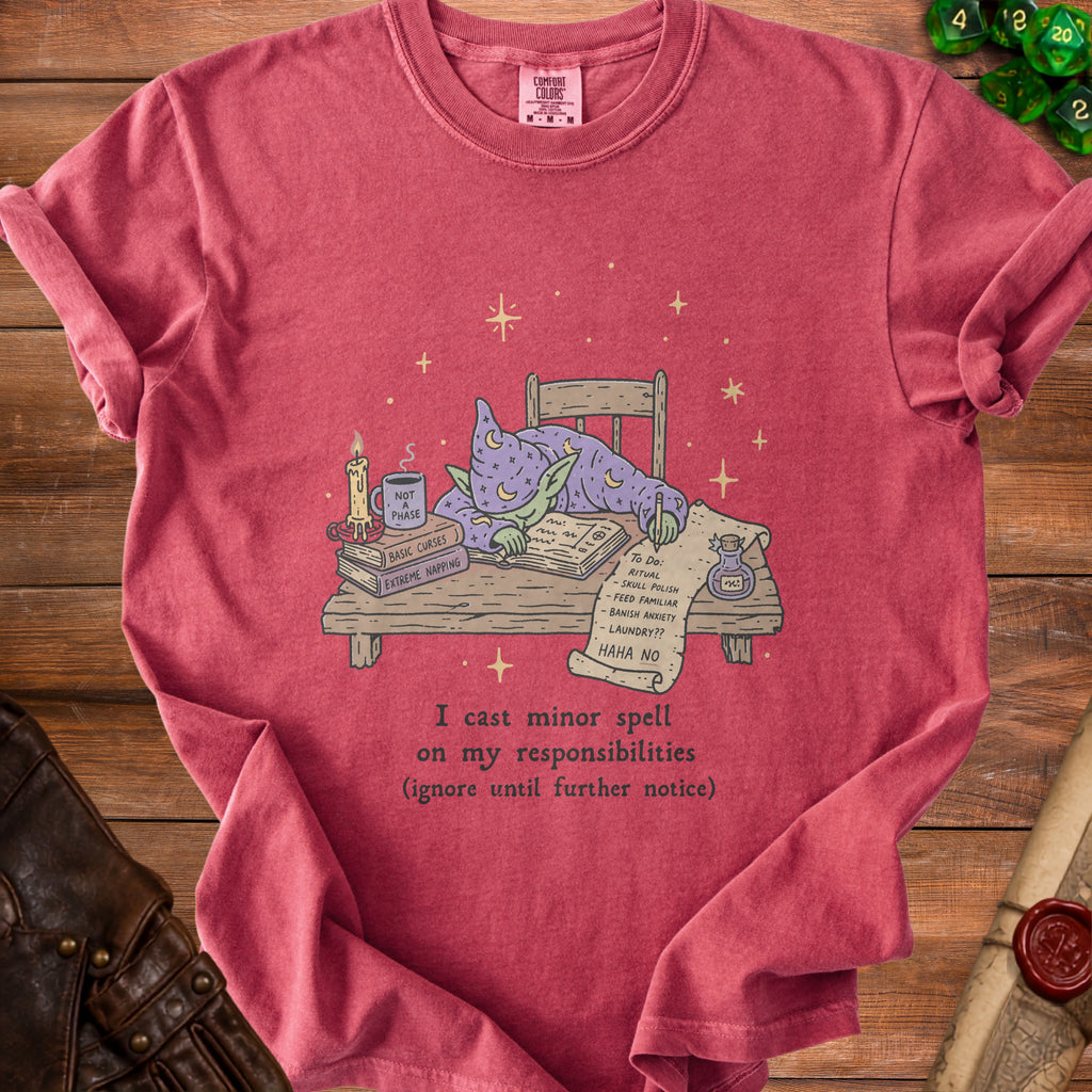 Red t-shirt with a cartoon wizard goblin sleeping at a desk.
