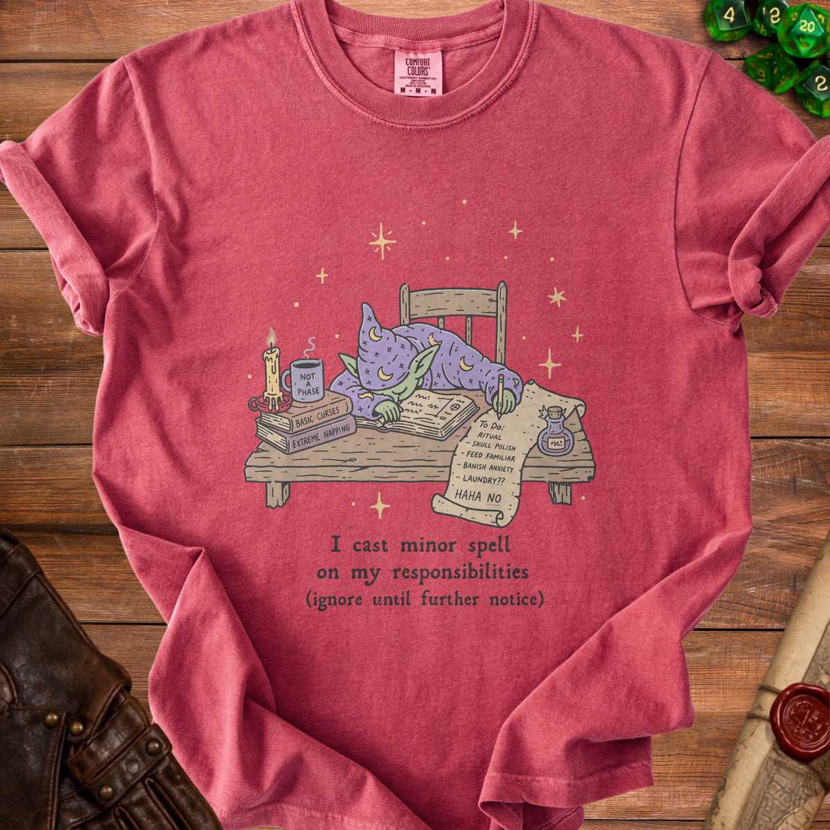 Red t-shirt with a cartoon wizard goblin sleeping at a desk.