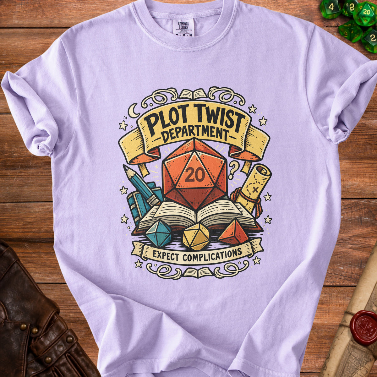 Lilac t-shirt with "Plot Twist Department" and "Expect Complications" graphic.