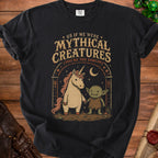Black t-shirt with "Us If We Were Mythical Creatures (You're The Goblin)" and illustration.