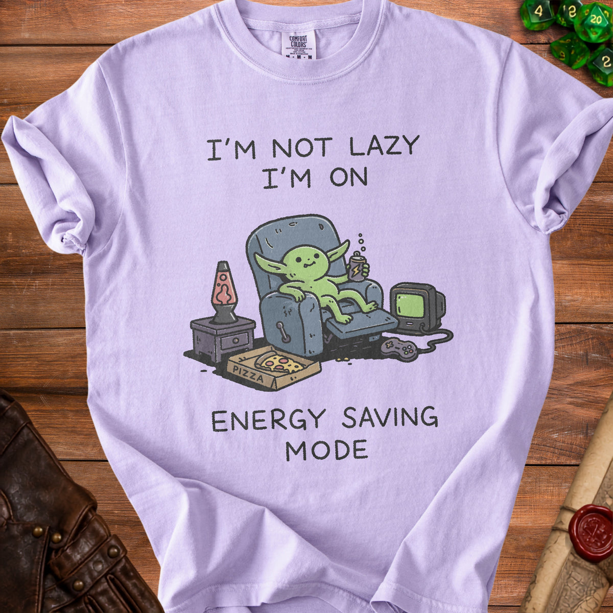 Lilac t-shirt with a goblin relaxing with pizza and a controller, saying "I'm not lazy, I'm on energy saving mode."