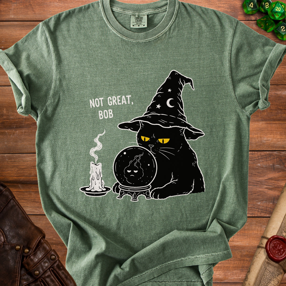 Green t-shirt with black cat wearing wizard hat, crystal ball, and candle. "NOT GREAT, BOB" text.