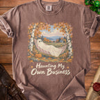 Brown t-shirt with ghost in hammock graphic and "Haunting My Own Business" text.