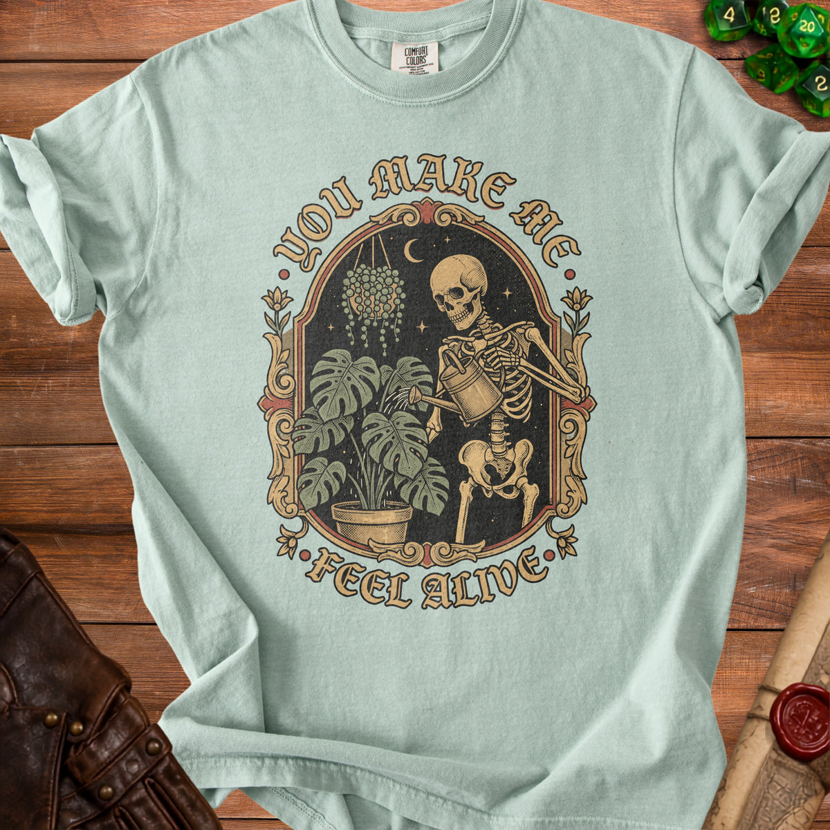 Skeleton watering plants with text "You Make Me Feel Alive".