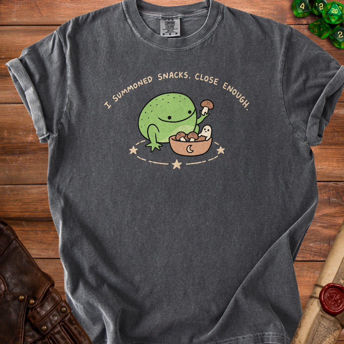 Dark grey t-shirt with a graphic of a frog summoning snacks and the text "I Summoned Snacks. Close Enough."