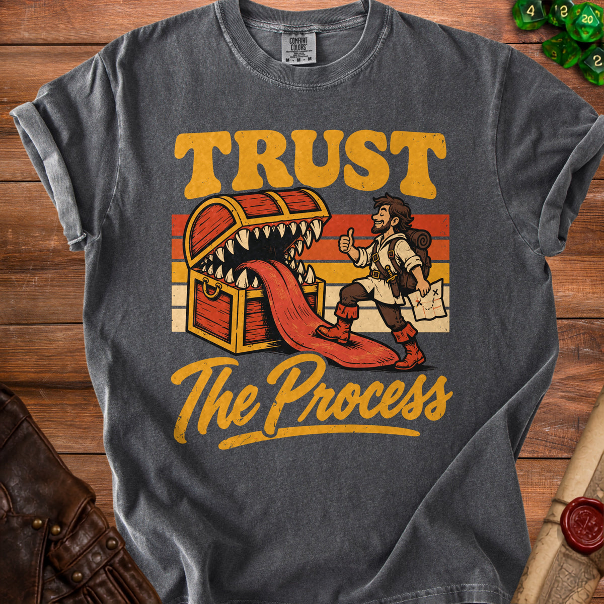 Graphic tee with treasure chest monster, adventurer, and text "TRUST The Process".