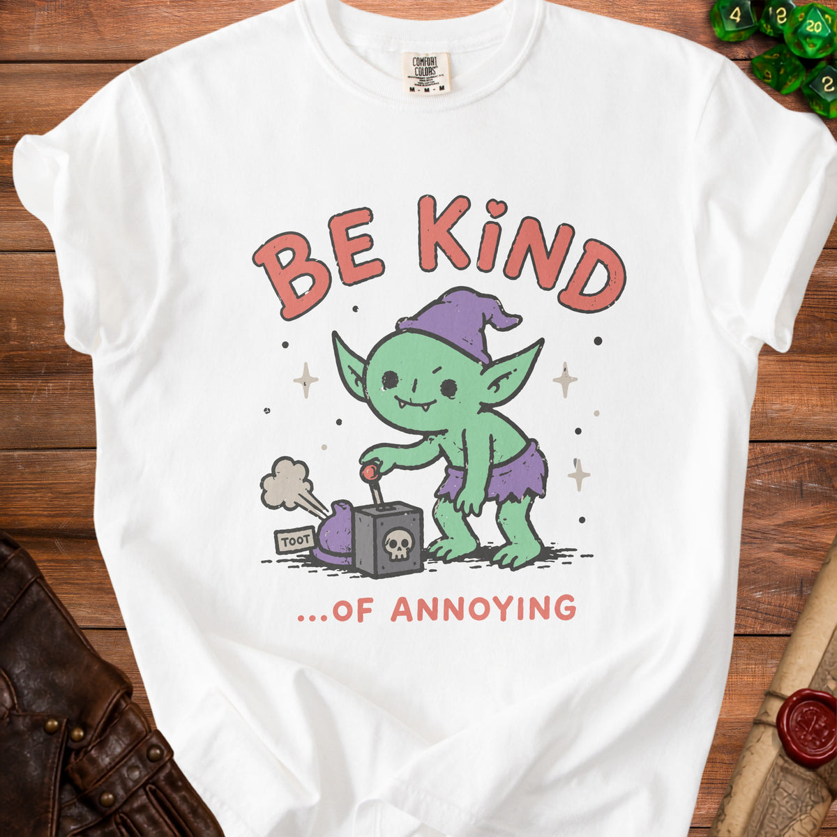 White t-shirt with a green goblin graphic that says "Be Kind ...Of Annoying".