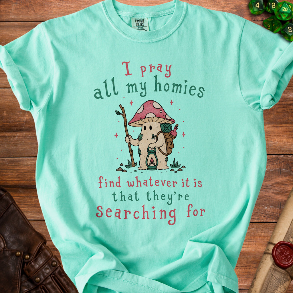 Mint t-shirt with mushroom character and text "I pray all my homies find whatever it is that they're searching for".