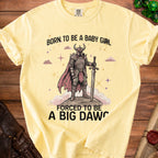 Pale yellow t-shirt with "Born to be a baby girl, forced to be a big daw" text and knight graphic.