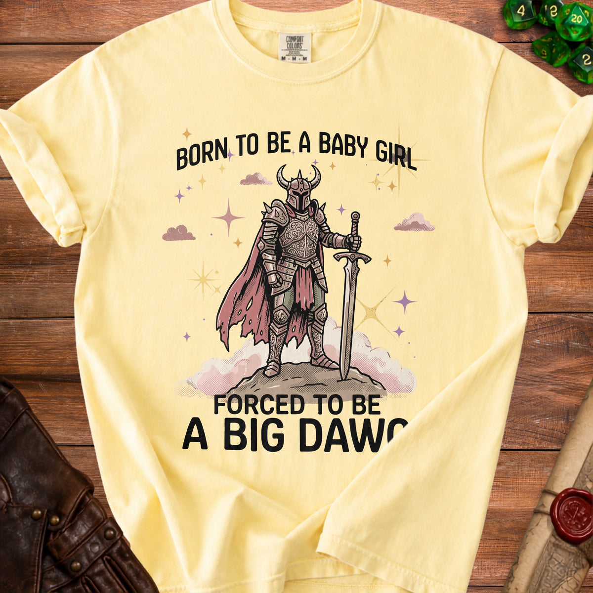 Pale yellow t-shirt with "Born to be a baby girl, forced to be a big daw" text and knight graphic.
