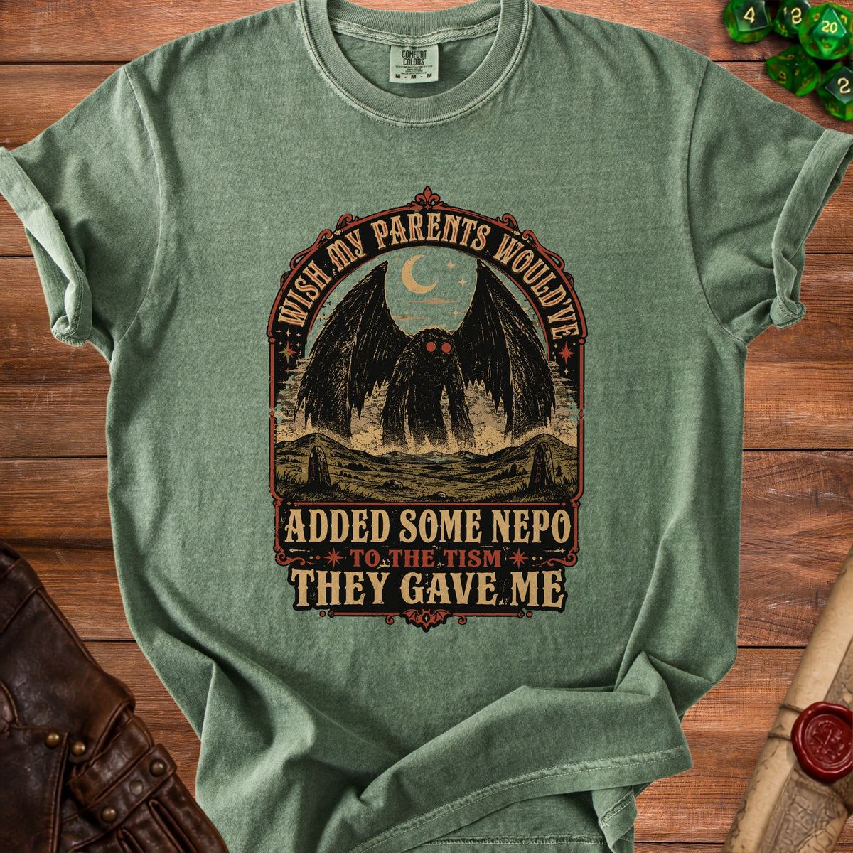 Green t-shirt with mothman graphic and text: "wish my parents would've added some nepo to the tism they gave me".