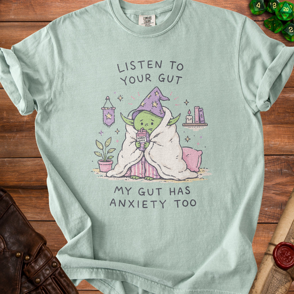 Mint green t-shirt with graphic of a green creature saying "Listen to your gut, my gut has anxiety too."