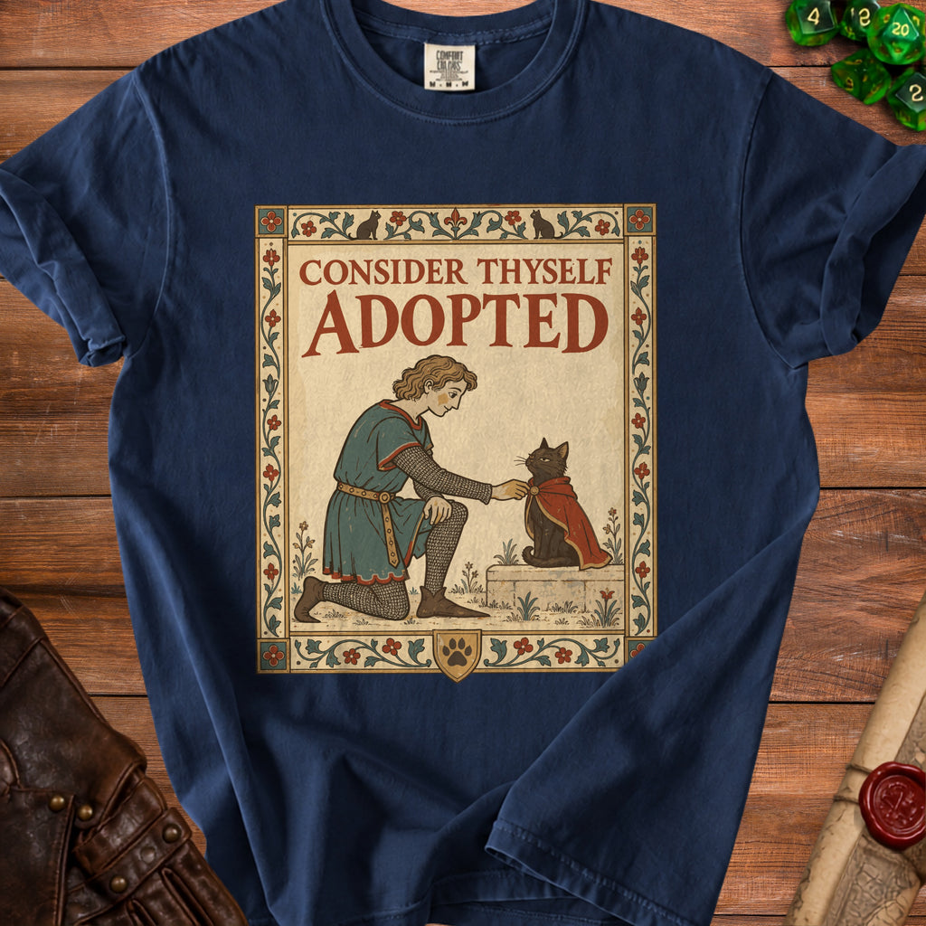 Navy t-shirt with "Consider Thyself Adopted" text, a kneeling figure and a cat.