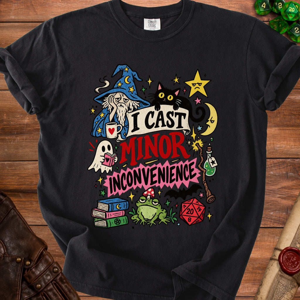 Black t-shirt with wizard, cat, ghost, frog, dice, and "I Cast Minor Inconvenience" text.