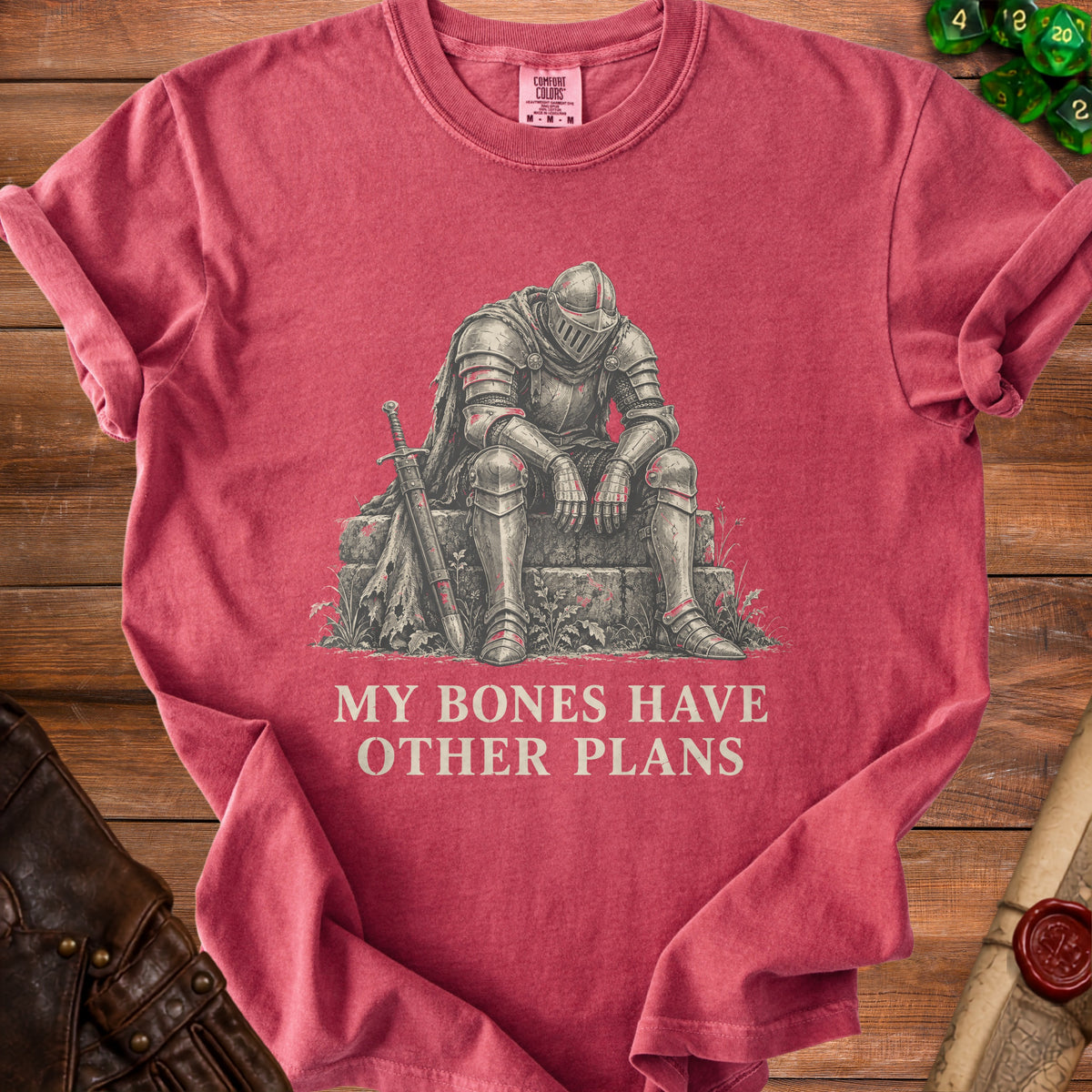 T-shirt with a tired knight illustration and "My Bones Have Other Plans" text.