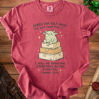 T-shirt with illustration of a green creature sitting on boxes and text.