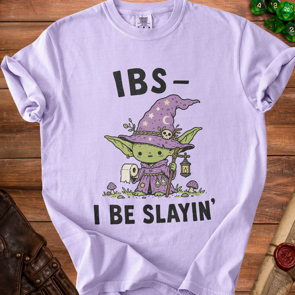 Lilac t-shirt with wizard character holding toilet paper and saying "IBS- I Be Slain'".
