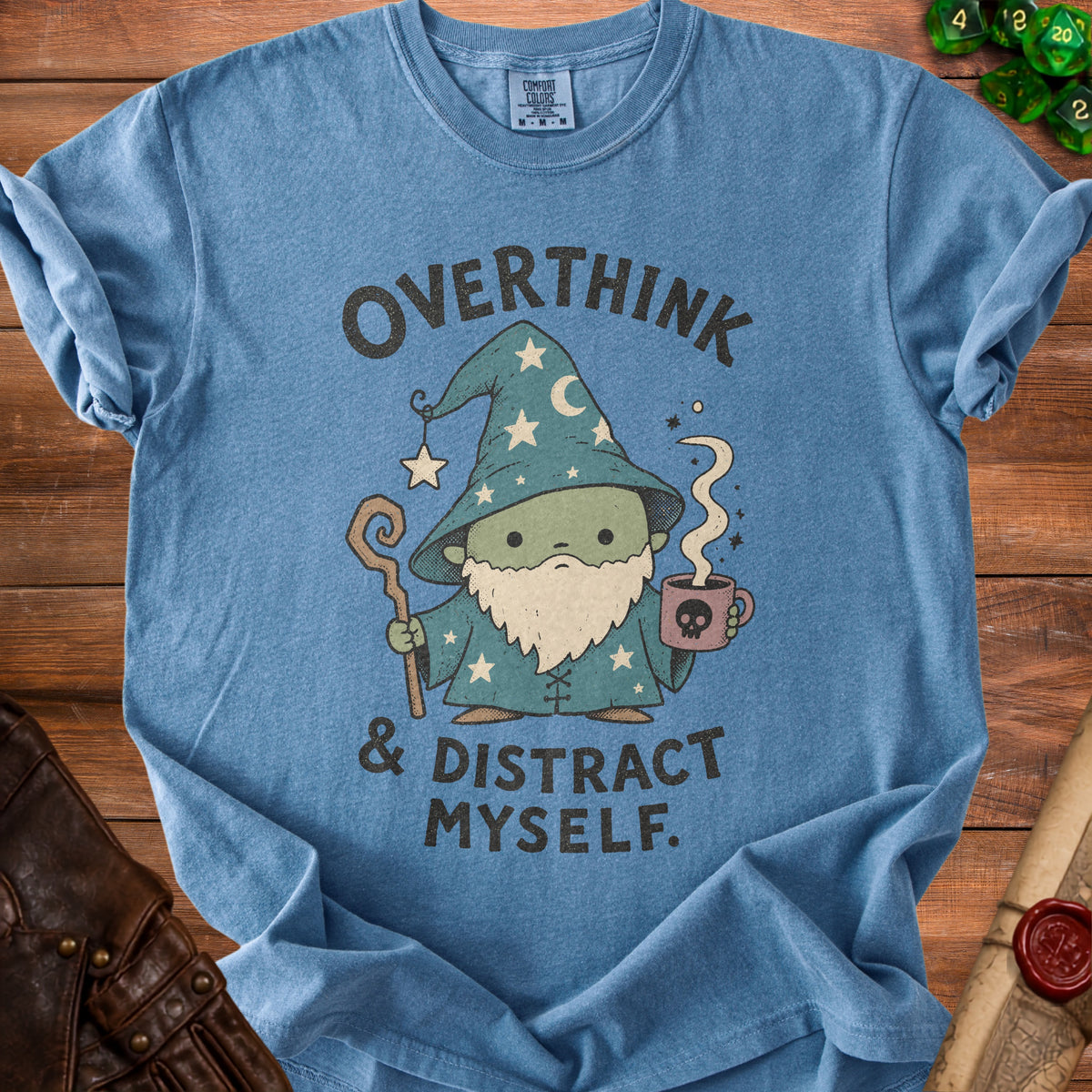 Blue t-shirt with a wizard holding a mug, reading "Overthink & Distract Myself."