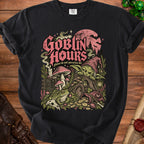 Black t-shirt graphic: goblin, toad, treasure, and mushrooms under a pink moon.