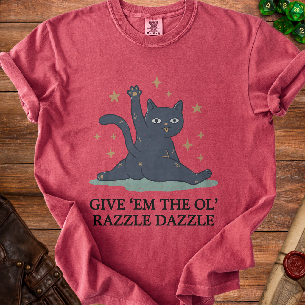 Red t-shirt with a cartoon cat raising a paw and text "GIVE 'EM THE OL' RAZZLE DAZZLE".