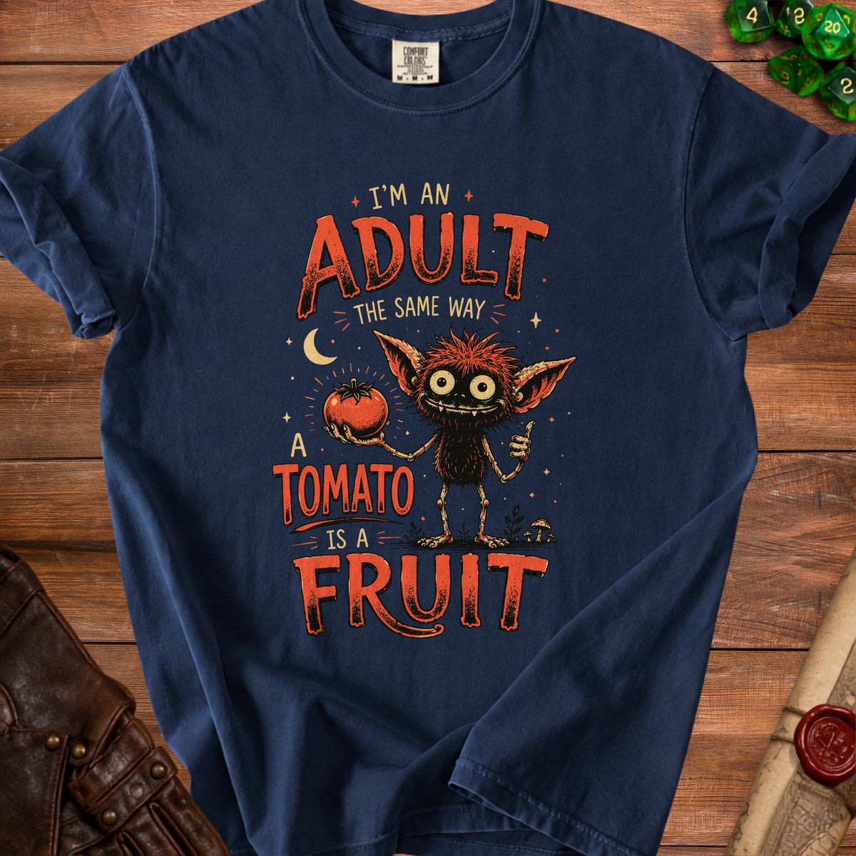 Navy t-shirt with "I'm an adult the same way a tomato is a fruit" graphic.