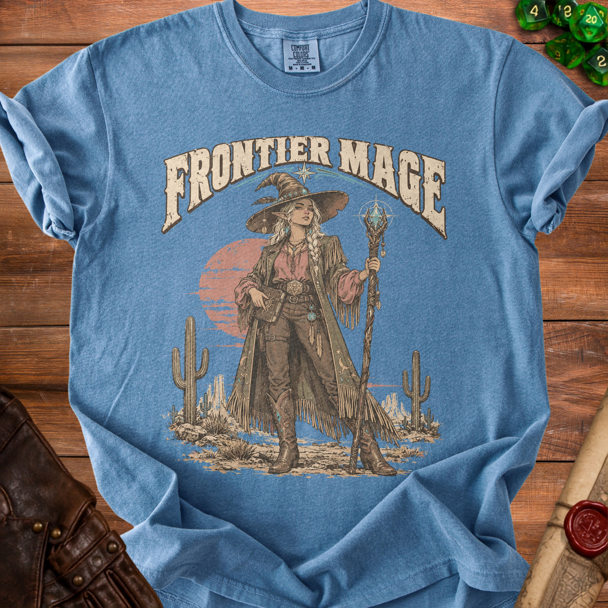 Blue t-shirt with "Frontier Mage" text and illustration of a western witch.