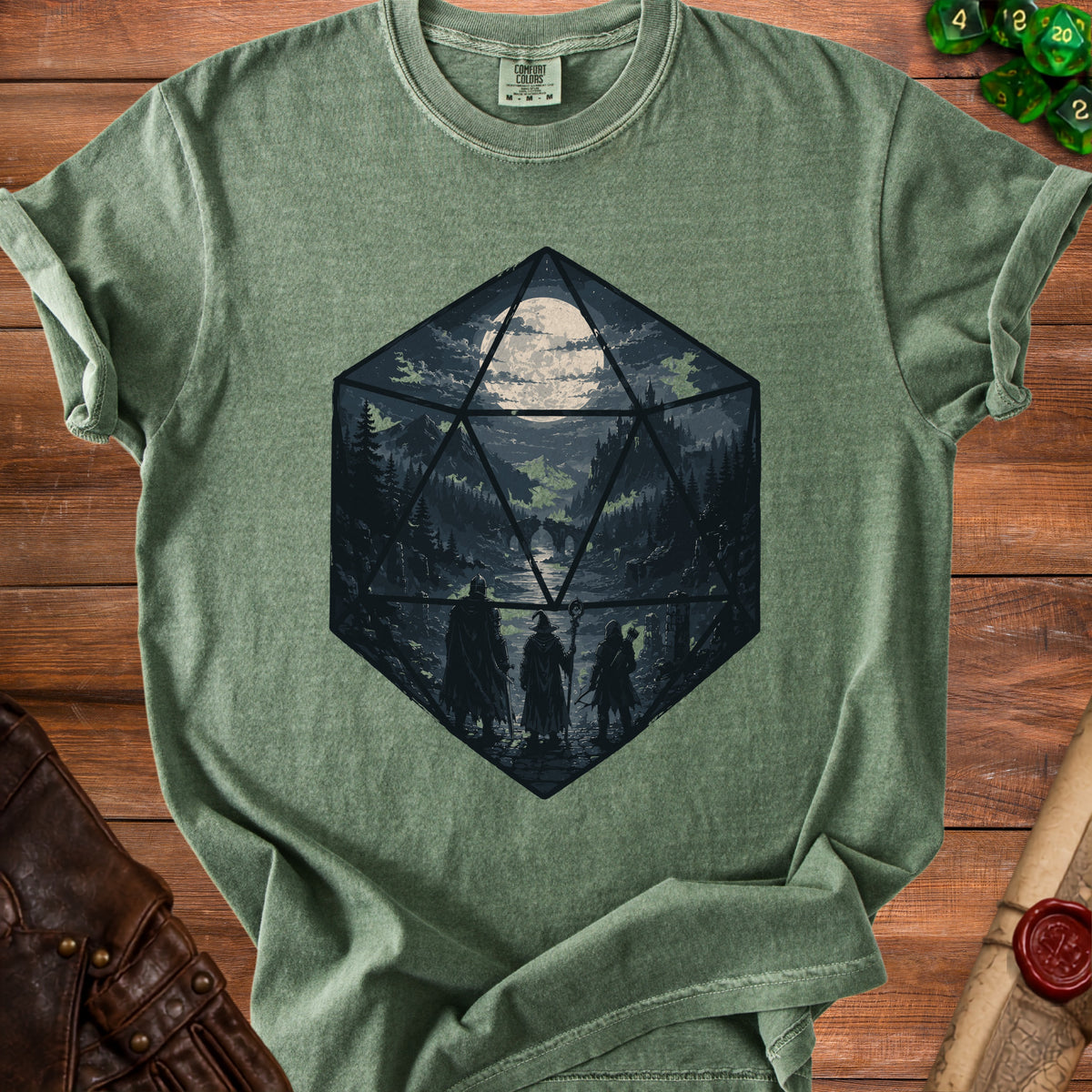 Green t-shirt with a D20 die graphic featuring a fantasy landscape and three adventurers.