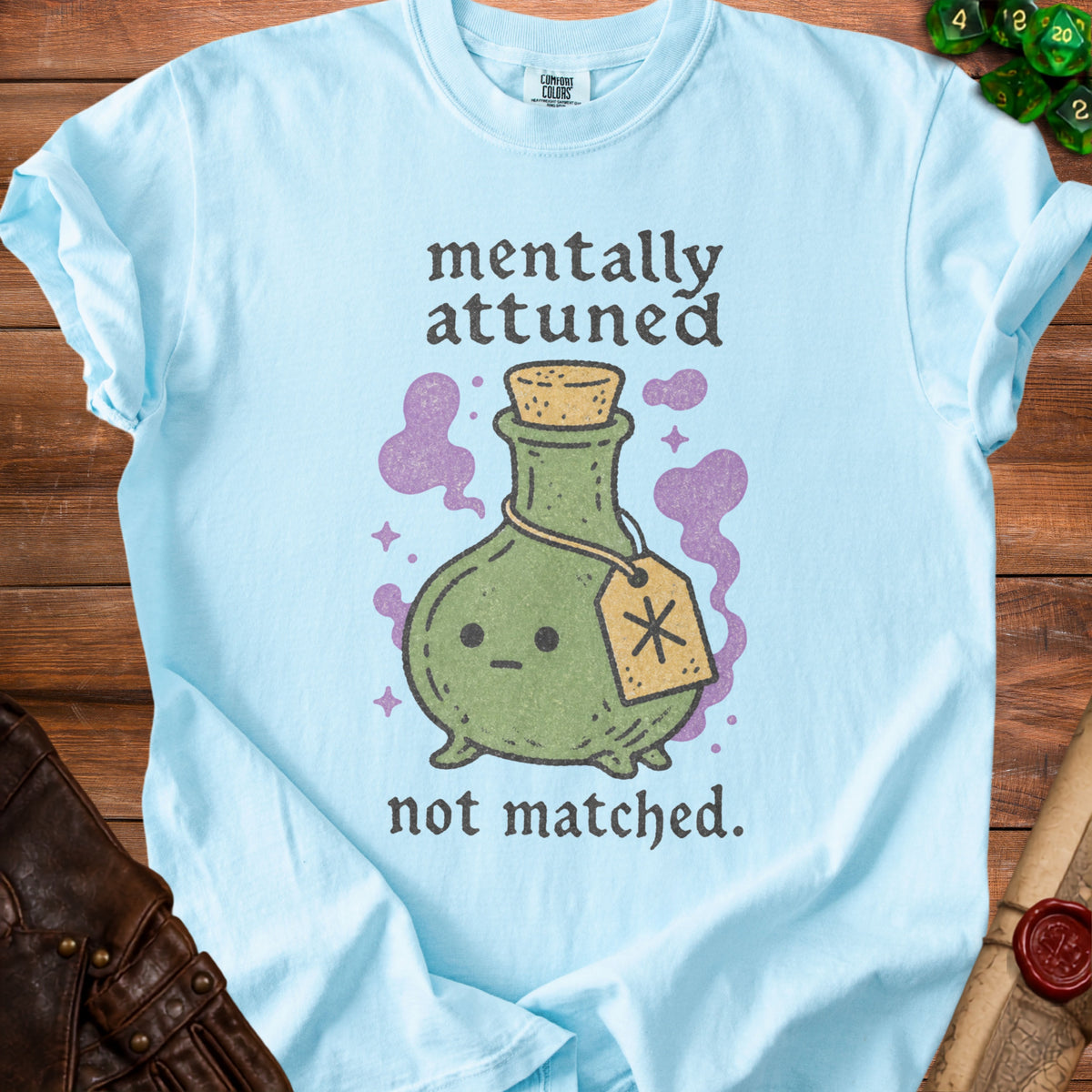 Light blue t-shirt with "mentally attuned not matched" text and a cute potion bottle.
