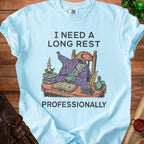Light blue t-shirt with "I NEED A LONG REST PROFESSIONALLY" and a sleeping wizard design.
