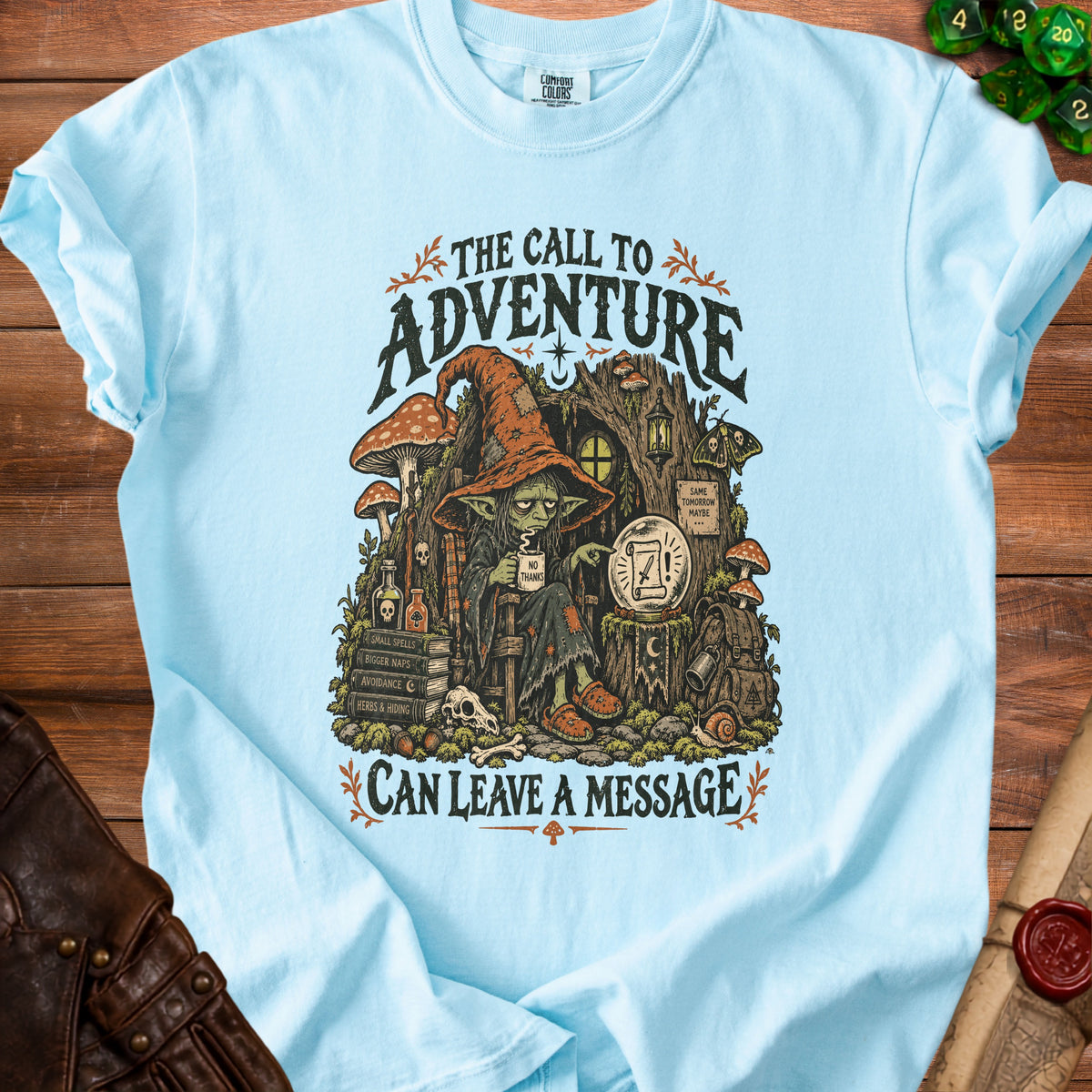 Light blue t-shirt with goblins, mushrooms, and text: "The Call to Adventure Can Leave a Message."