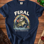 Navy t-shirt with a wizard opossum on a frog under a rainbow, text "FERAL but in a whimsical way".