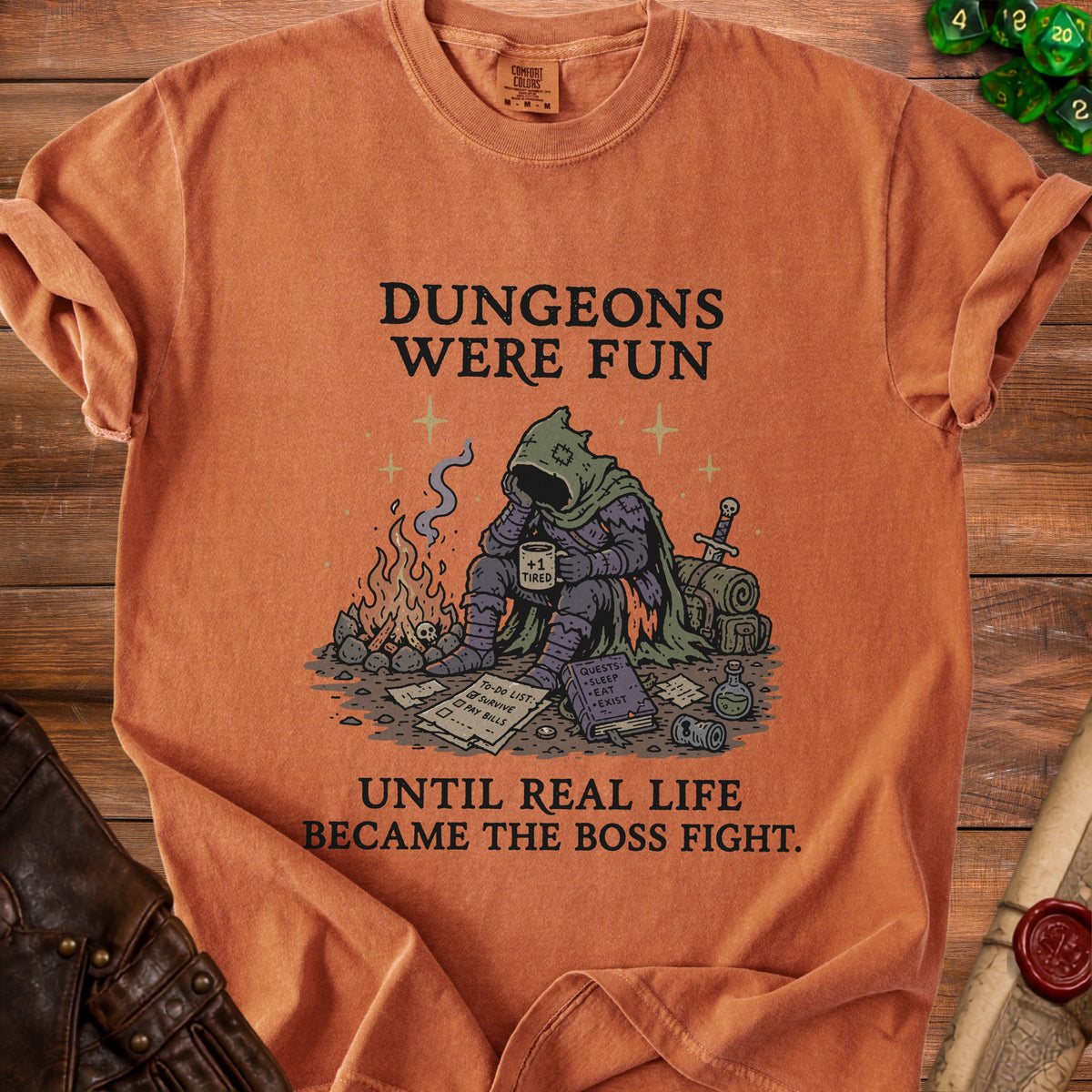 Orange t-shirt with graphic: "Dungeons were fun until real life became the boss fight."