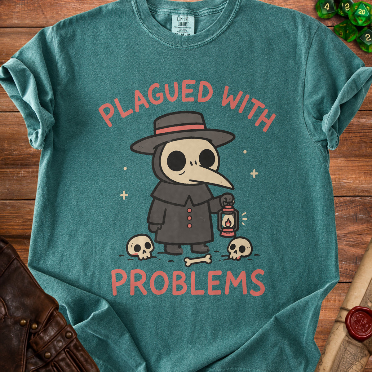 Plague doctor illustration with text "PLAGUED WITH PROBLEMS" on teal t-shirt.